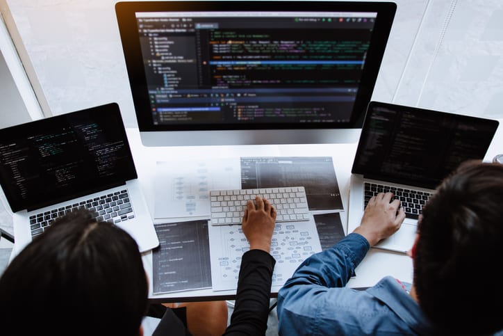 Professional development programmer cooperating meeting programming website working a software in office room. Professional development programmer cooperating meeting programming website working a software in office room.